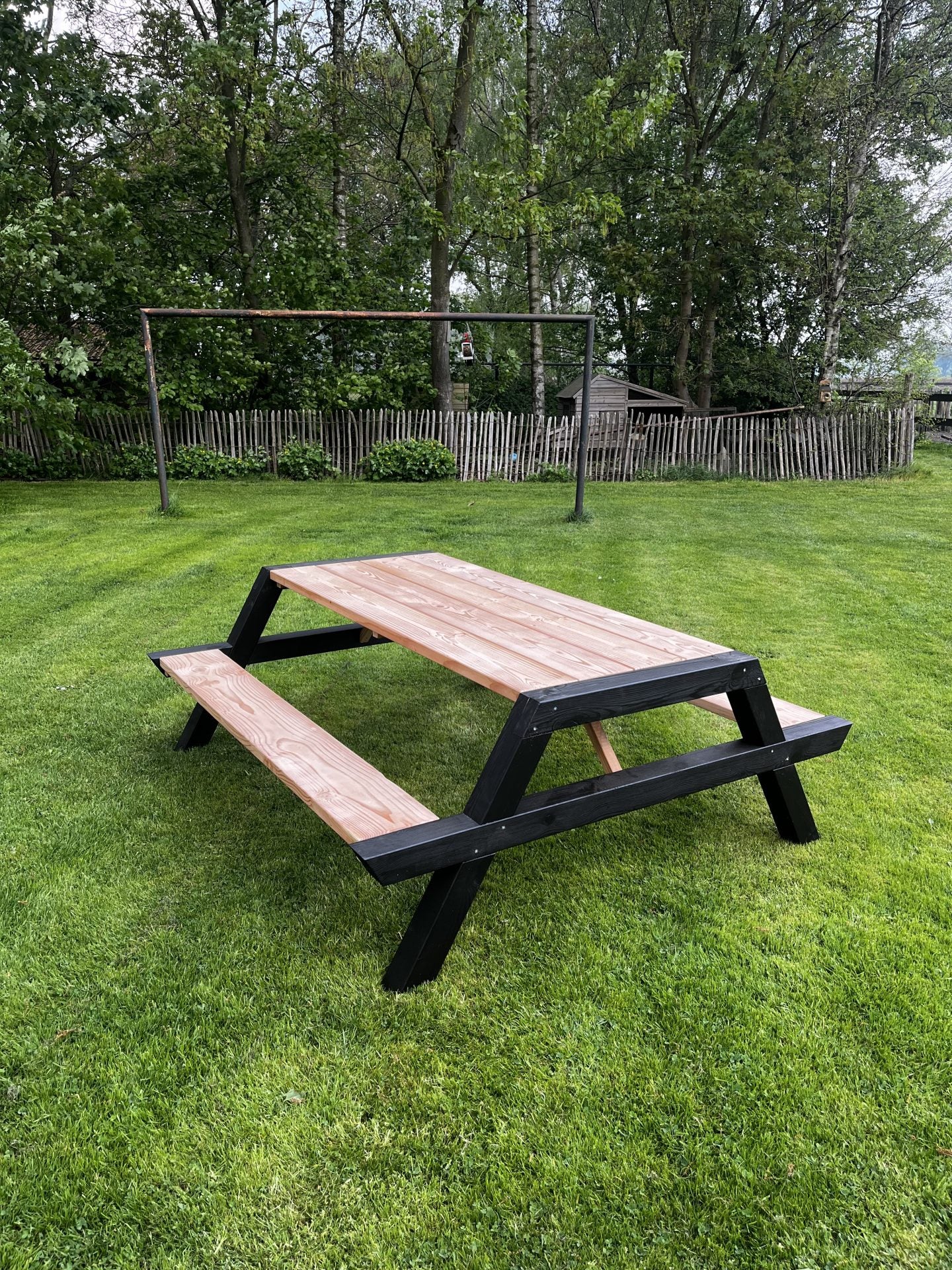 Picknicktafel Noir met zwart gelakte poten, vooraanzicht in de tuin
